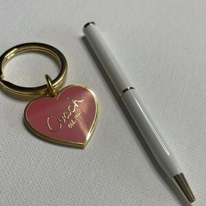 Coach Gold and Pink Heart Key Holder with a White Coach Pen